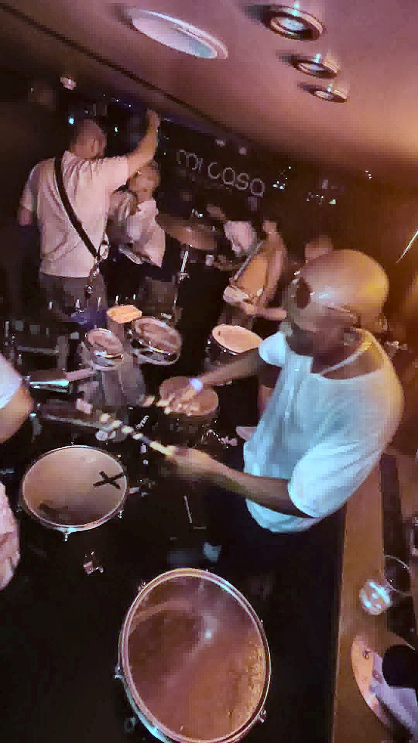 Live percussion performance alongside a DJ at a boat party